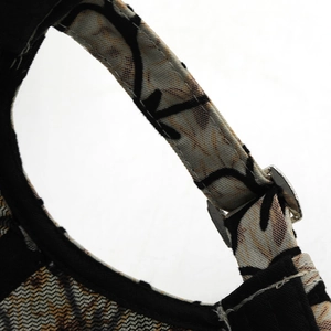 Detailed macro view of the floral mesh fabric and adjustable metal buckle on baseball cap