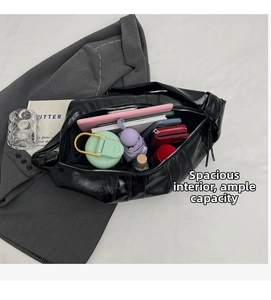 Interior view of large black leather dumpling bag showing high capacity for daily items