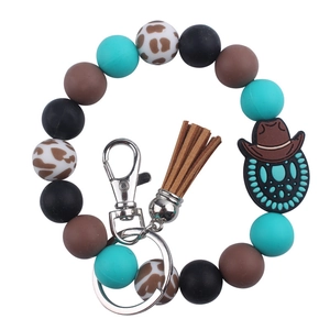 Western style silicone bead wristlet keychain with cow print and leather tassel detail