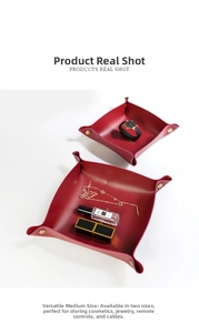 Macro shot of red leather storage trays with golden snap buttons and minimalist design