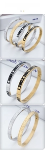 Detailed views of sun moon and star patterns on gold and silver stainless steel bangles