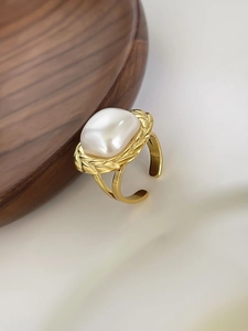 Macro shot of 18K gold-plated adjustable ring featuring a large Baroque pearl with braided texture