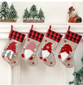 Detailed view of four gnome Christmas stockings hanging on a white festive mantel