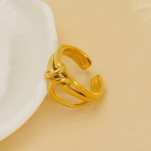 Minimalist irregular 18K gold plated stainless steel open ring on elegant white ceramic