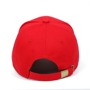 Detail view of red cotton baseball cap featuring classic six-panel design and bronze buckle