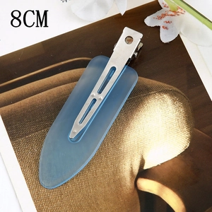 Detailed macro view of 8CM translucent blue leaf duckbill hair clip with silver metal