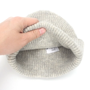 Light gray knit beanie with R embroidery and soft ribbed texture for winter warmth