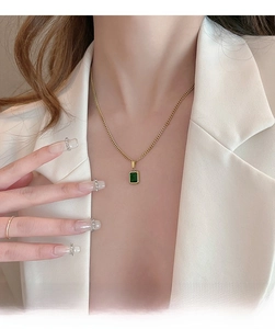 Detailed view of emerald green rectangular pendant on a fine gold-plated titanium chain