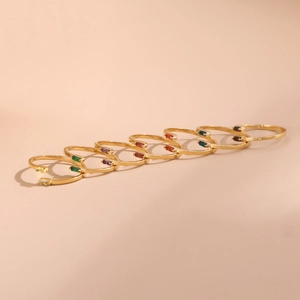 Set of seven gold plated open rings with colorful micro-set baguette zircon gemstones