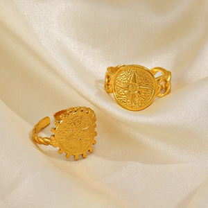 18K gold plated coin rings with starburst engraving on draped silk background