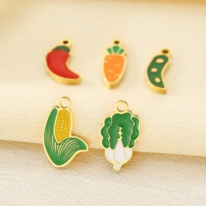 Detail of five gold-plated enamel vegetable pendants including carrot and corn charms