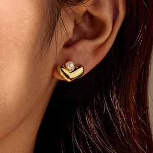 Boucles d'oreilles cœur en acier inoxydable doré 18K avec perle portées par mannequin
