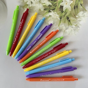 Rainbow teacher appreciation pens set with inspiring quotes on a white desk background