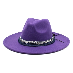 Detail of purple fedora hat with sequined ethnic band and navy blue fringe trim