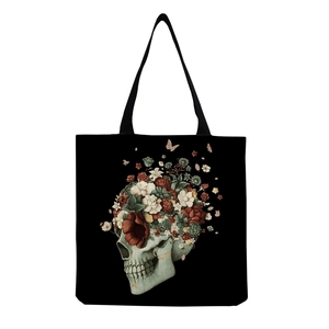 Close-up of vintage floral skull art print on black canvas tote bag showing texture