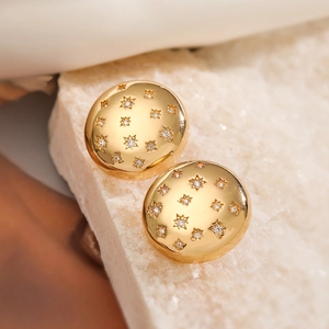 Minimalist 18K gold-plated copper star earrings with zircon inlay on white marble stone