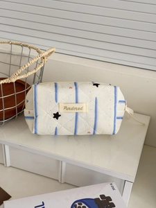 Quilted blue star and heart pattern makeup bag with vertical stripes and zipper closure