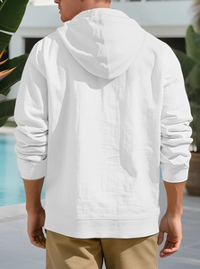 Rear view of white linen cotton hoodie with hood and ribbed cuffs on a poolside background