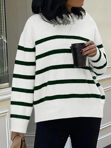 Detail view of casual white sweater with green stripes and soft knit texture finish