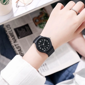 Close-up of kids black quartz watch with silicone strap worn by model in lifestyle setting