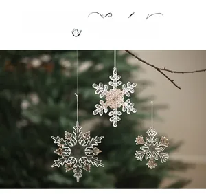 Macro detail of acrylic snowflake ornaments with gold glitter for Christmas trees
