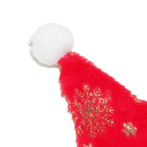 Detail of red plush Santa hat with golden snowflake patterns and white pom-pom