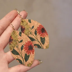 Handcrafted leaf-shaped cork earrings with retro floral patterns and gold hooks