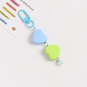 Detail of colorful matte heart beads and blue metal clasp on a stylish keychain