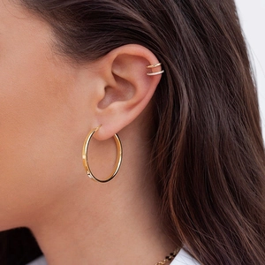 U-shaped 18k gold plated cuff set with zircon stones on female ear model