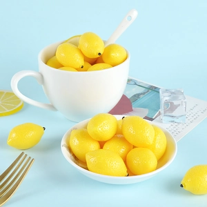 Lifelike yellow mini lemon models in a white ceramic cup on a fresh blue background