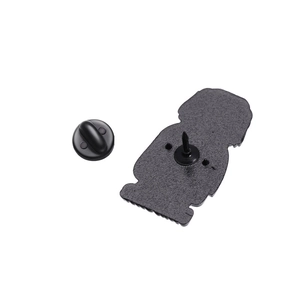 Macro view of animal enamel pin metal needle back and black rubber clutch closure
