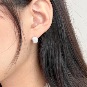 Close-up of a woman wearing a silver rectangle earring with micro-pave cubic zirconia