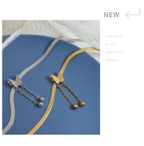 Detail of adjustable butterfly tassel necklace with snake chain in gold and silver