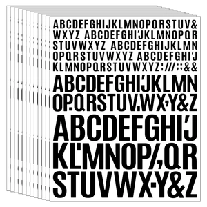 Close-up of stacked black uppercase alphabet stickers in various sizes for scrapbooking