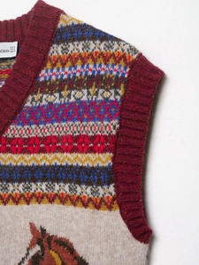 Detail of vintage Fair Isle knit vest with horse pattern and maroon ribbed neckline