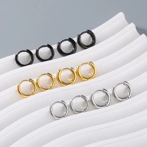 Three pairs of classic round stainless steel hoop earrings in black, gold, and silver finishes