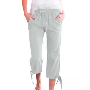 Detail of light blue cotton linen cropped wide-leg pants with drawstring waist and tied cuffs
