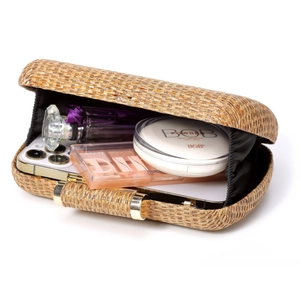Open view of straw weave clutch showing interior storage for phone and cosmetics