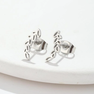 Close-up of silver stainless steel earrings with minimalist hollow wheat leaf design