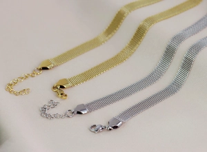 Detail of gold and silver mesh choker necklaces with lobster clasp and extension chain
