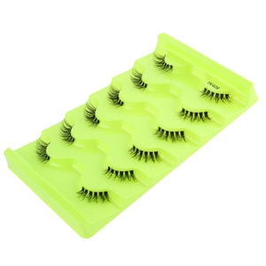 Detailed view of five pairs of black half-eyelashes with clear bands on a green tray