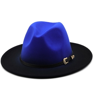 Detail of blue and black fedora hat with felt texture and gold vintage buckle