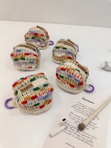 Handmade woven mini earphone pouches in vibrant colors with secure zipper and hook