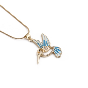 Golden hummingbird necklace with blue enamel and sparkling crystals on snake chain
