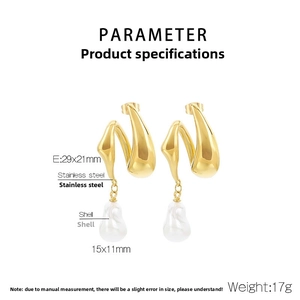 Detail view of gold twisted earrings with baroque shell drops and measurement specs