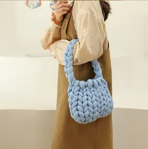Detailed texture of light blue chunky knit handbag made of thick woven cotton yarn