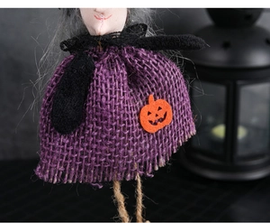Detail of Halloween witch doll featuring purple burlap dress and orange pumpkin accent