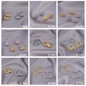 Collection of nine luxury geometric earrings in gold and silver finish on silk