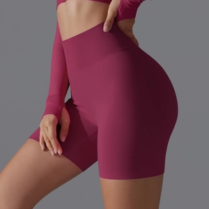 Close-up of seamless burgundy high-waisted yoga shorts with honeycomb texture and push-up effect