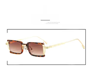 Detailed view of tortoise shell rectangular frames with gold metal temples and brown lenses